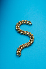 yellow gold bracelet, over blue background. jewelry concept