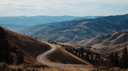 Dramatic Mountain Scenery with Winding Road Cutting Through Scenic Landscape and Rolling Hills