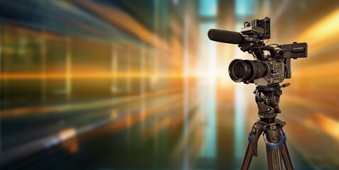 video camera filming on luminous background with copy space
