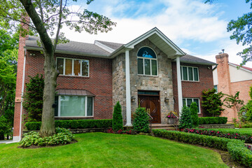 Suburban home in private residential housing. House exterior architecture. Housing in neighborhood. Private house architecture. Private housing property. Residential suburban house. Dwelling exterior