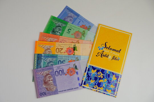 Money packet or translated as sampul duit raya in Malay with Ringgit Malaysia Notes for Ramadhan and Eid Fitr Celebration on isolated background. Selective focus. known as Duit raya 