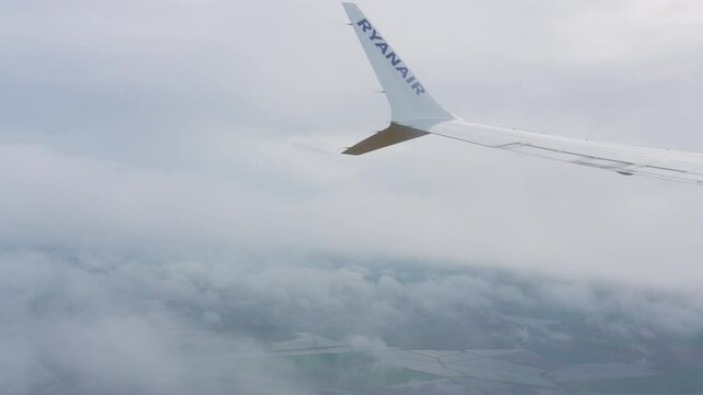 Approaching Lisabon during cloudy skies with views of the lush countryside and fields below