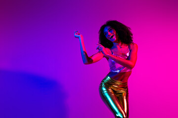 Portrait of a young woman enjoying nightlife in radiant neon hues with a fashionable and trendy appearance