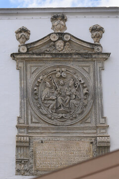 Stone bas-relief of a medieval religious symbol decorating the Arco del Postigo, Seville, Spain