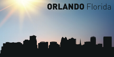 Cityscape, architecture, silhouette of the city of Orlando, Florida on the background of the sunset.