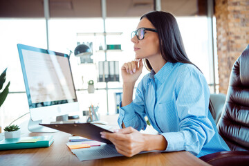 Professional Woman in a Bright Office Setting Focused on Work Activities