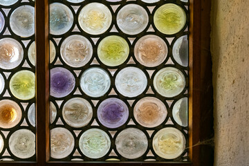 Colorful stained glass window displays unique patterns and hues in historic building