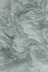 Textured crumpled paper in pale turquoise