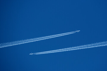 Two contrails. Airplane trail in the clear blue sky