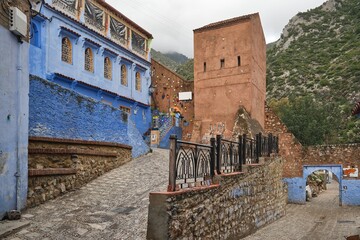 Inner medina view of restaurant and the Bab El Onsar medina walls gate leading to Ras El Mar waterfalls, Chefchaouen, Morocco