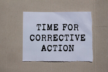 Time for corrective action message written on ripped torn paper on cardboard background. Conceptual time for corrective action symbol. Copy space.