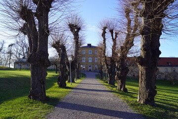 The old charming historical architecture of the yellow castle Ulfsunda Slott in Stockholm, Sweden
