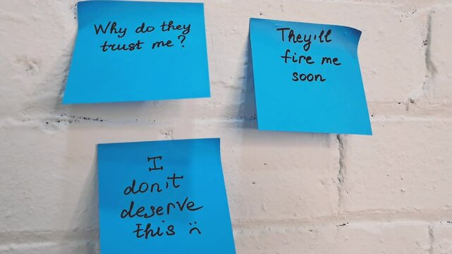 Sticky notes represent self-doubt and the emotional struggle of imposter syndrome.