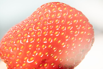 Close-up texture detail of a strawberry, See the seeds attached to the outer surface, red, beautiful.