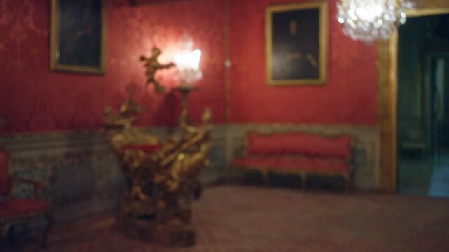 Blurred view of the ornate galleria doria pamphilj interior with red walls, gilded furniture, and chandelier, highlighting the opulent art and decor of this historic italian museum.