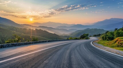 A winding road with a beautiful mountain range in the background.