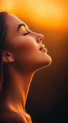 Serene woman with auburn hair embraced by warm light at sunset