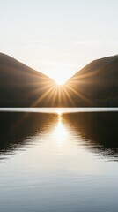 Tranquil mountain landscape at sunset with sun reflecting on lake waters