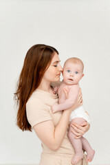 a mother with a baby on a white isolated background, a place for text, a young mother gently hugs her little child, a girl in diapers, maternal love and care