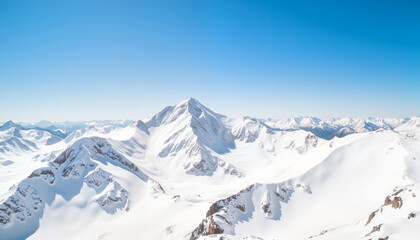 Obraz premium Majestic snow-covered mountain peaks under clear blue sky, winter beauty