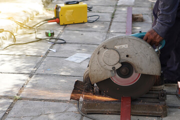 The technician is using a steel cutter