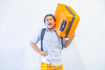 Portrait Asian muslim man carrying suitcase . Concept Going home for Eid Mubarak. Isolated image on white background