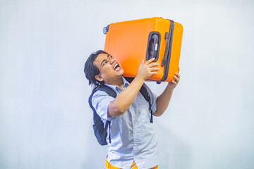 Portrait Asian muslim man carrying suitcase . Concept Going home for Eid Mubarak. Isolated image on white background