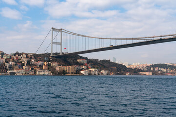 View of Sultan Mehmed Fatih Bridge and the embankment of the European part of Istanbul from the water area of the Bosphorus on a sunny day, Istanbul, Turkey