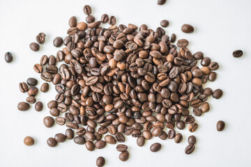 Whole coffee beans on a light background