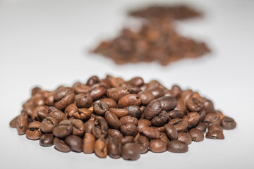 Whole coffee beans on a light background