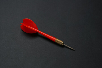 One red dart arrow on black background