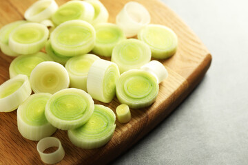 Fresh cut leeks on grey table, closeup