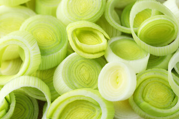 Pieces of fresh chopped leeks as background, closeup