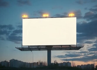 Large blank billboard illuminating the evening sky with clouds and city lights