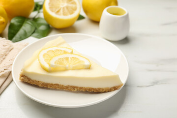 Piece of delicious lemon cheesecake on white marble table, closeup