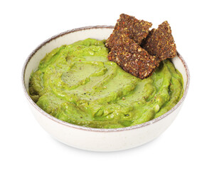 Tasty avocado dip in bowl and crispbreads isolated on white