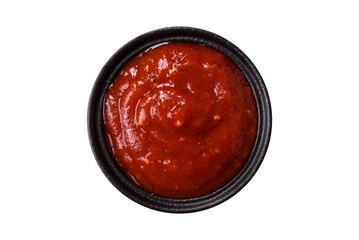 Red sauce or ketchup with salt and spices in ceramic sauce boat