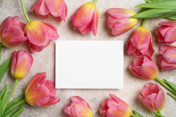 Blank wedding invitation or greeting card mockup with tulips flowers decor, white card mock up with copy space