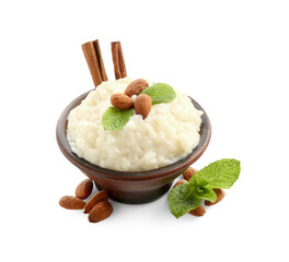 Delicious rice pudding with almonds, mint and cinnamon sticks isolated on white