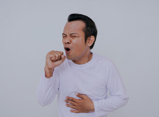 Sick man wearing long sleeve white coughing, sore throat and coughing as symptom for cold or...