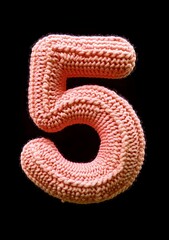 Knitted number five in warm orange tones