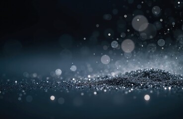 Abstract photo of dust particles on black background with bokeh blur overlay. Dynamic composition with copy space. Fairy dust. Artistic background for design, product promotion, beauty projects,