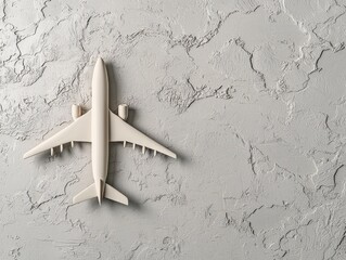White Airplane Model on Gray Textured Background