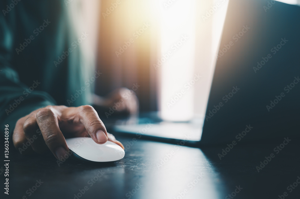 Poster a professional business setting featuring a close-up of a hand gripping a computer mouse on a sleek,