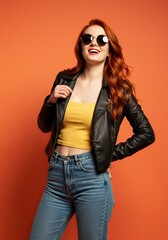 Fototapeta premium Stylish Redhead Woman in Leather Jacket and Sunglasses