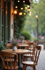Obraz premium Cozy cafe terrace with wooden tables chairs, flowers in white vase. Outdoor restaurant cafe with string lights. Classic bistro with cozy atmosphere, perfect for relaxing, enjoying drinks. Cafe