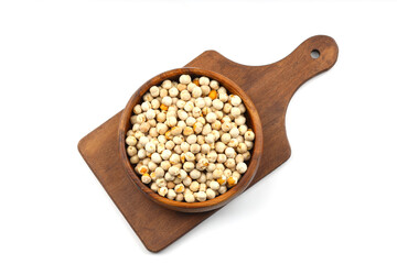 Roasted white chickpeas in wooden bowl on white background, top view. White chickpeas, with their high fiber content, are very healthy to consume.