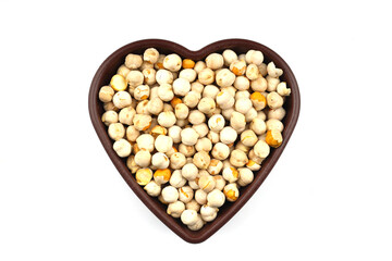 Roasted white chickpeas in wooden bowl on white background, top view. White chickpeas, with their high fiber content, are very healthy to consume.