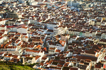 Fototapeta premium Nazare village, Portugal. A breathtaking aerial photograph captures an incredibly picturesque cityscape filled with vibrant red rooftops