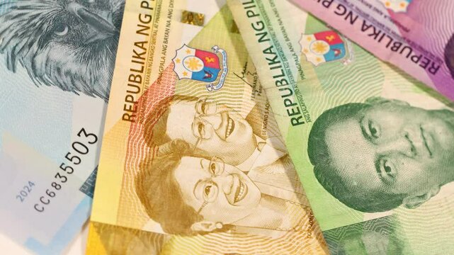 Philippines money. Philippine peso banknotes rotating. Symbol of financial success, winning the lottery, financial concept. close up, flat lay